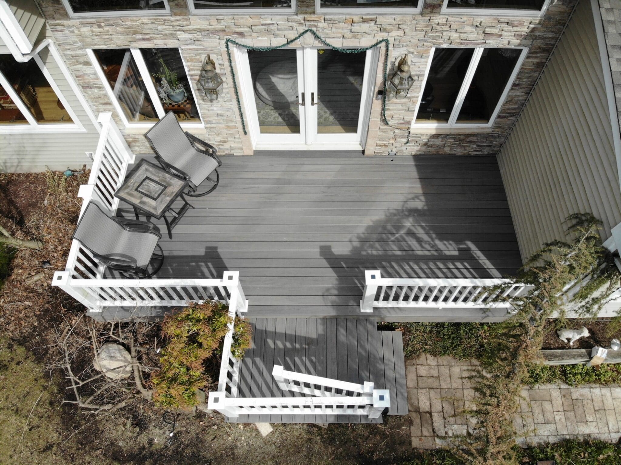 gray deck installation by blue nail exteriors