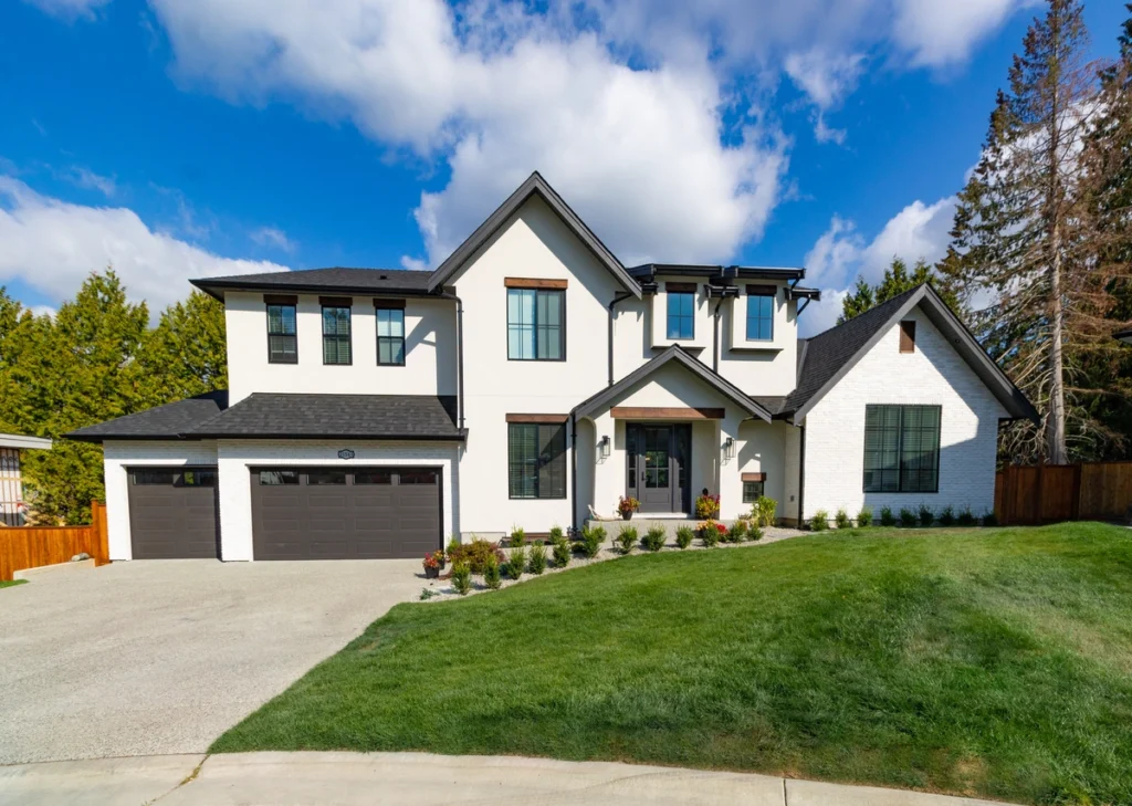 beautiful house with black shingle roof